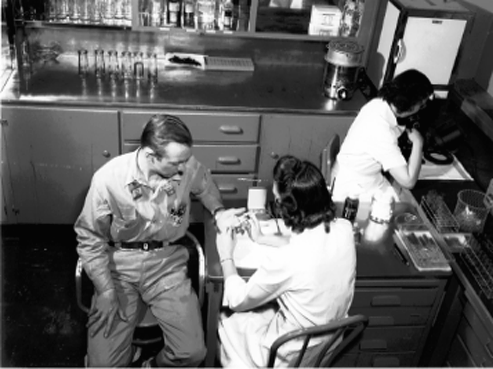 An employee having a blood test to detect radiation exposure